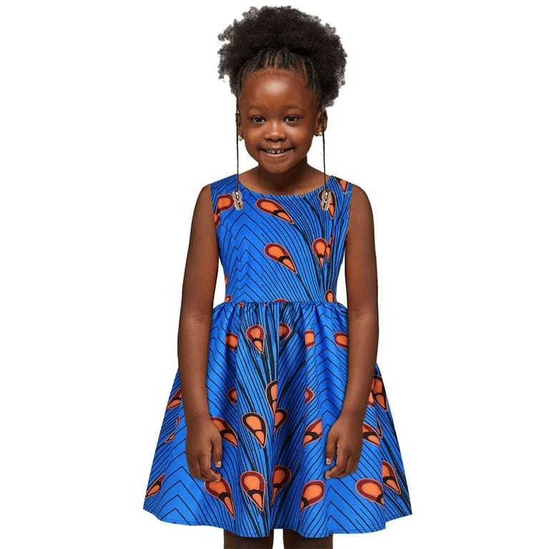 Girl in royal blue Ankara flare dress with peacock print