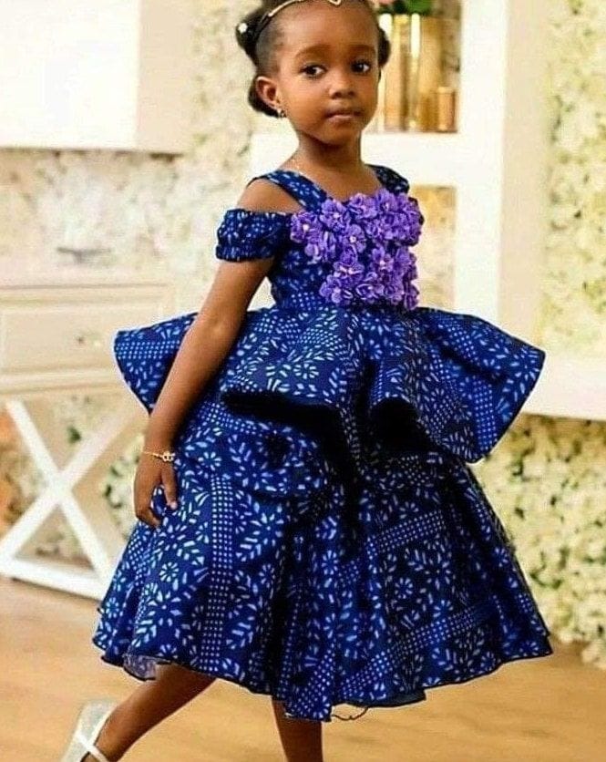 Girl in royal blue layered Ankara party dress with purple florals