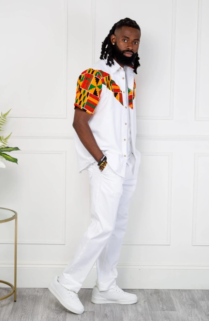 Man in white Kente-accent shirt and trousers