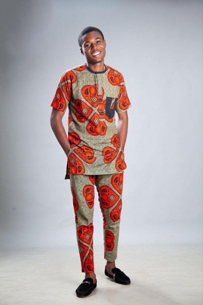 Man in orange and red paisley Ankara short-sleeve tunic and trousers