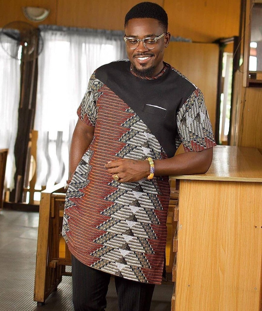 Man in black and geometric Ankara diagonal split short-sleeve tunic