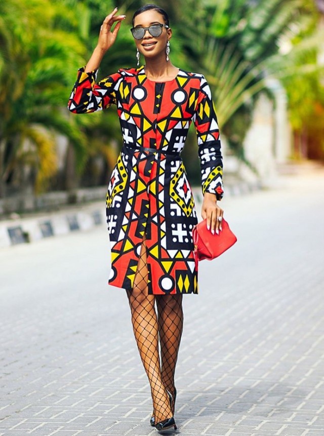Model in a red and yellow geometric Ankara long-sleeve midi dress
