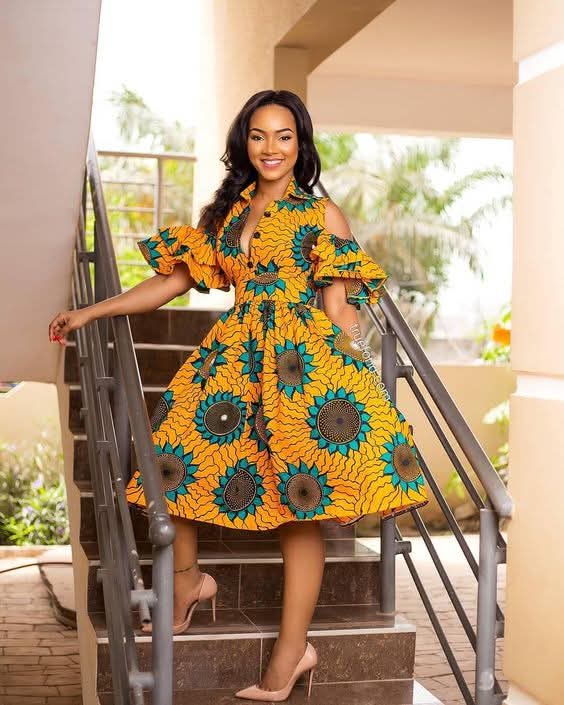 Model in yellow sunflower print Ankara shirt dress with ruffled cold shoulders