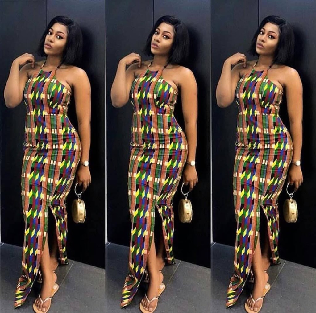 Model in colourful halter-neck Ankara maxi dress with high slit