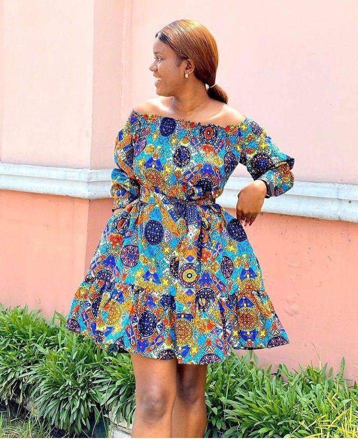 Model in blue and orange off-the-shoulder tiered Ankara mini dress